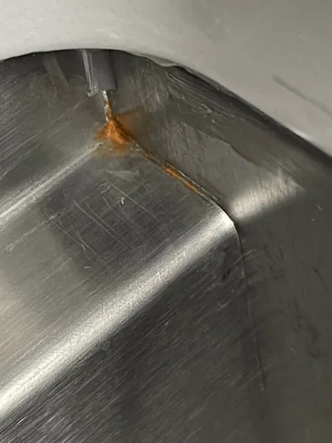 a close up of what rust particles close up in a sink will look like after sitting for too long